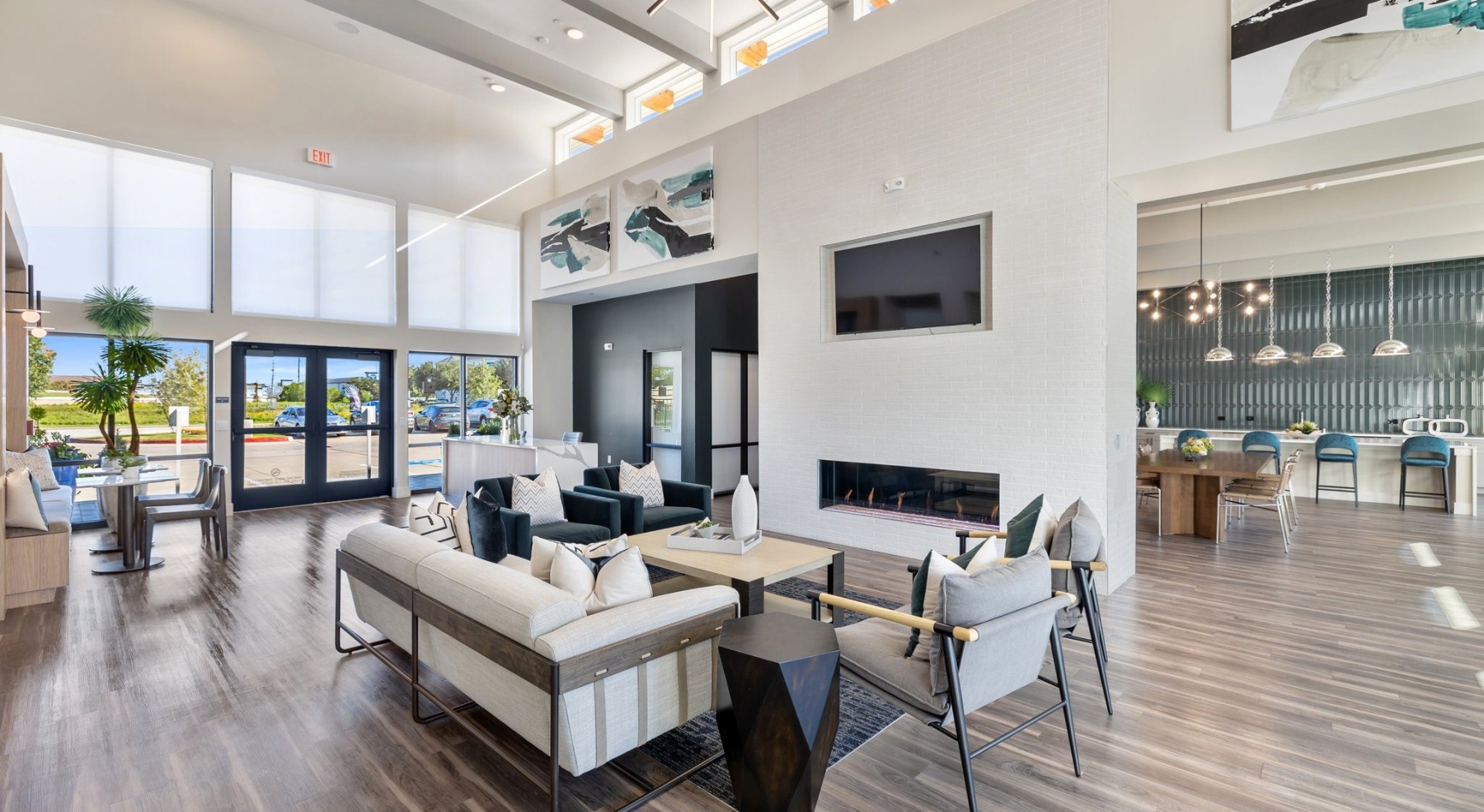a spacious clubroom with a sofa and a media area