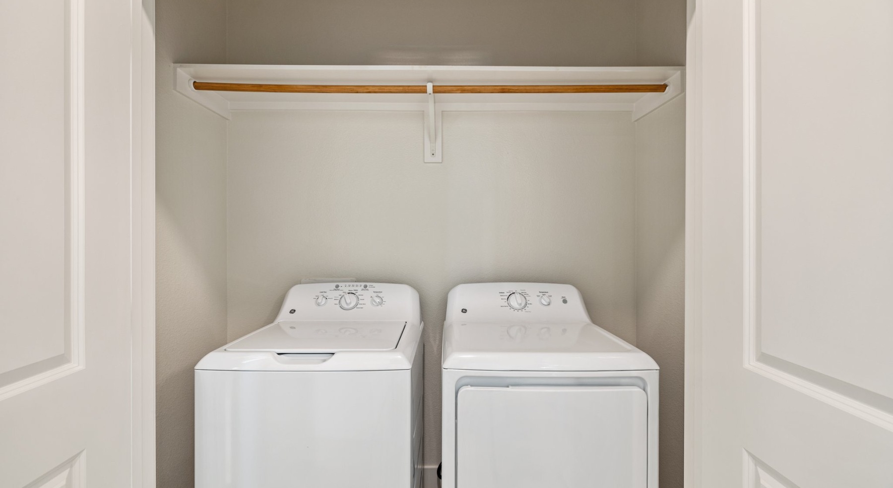 a laundry closet with shelving