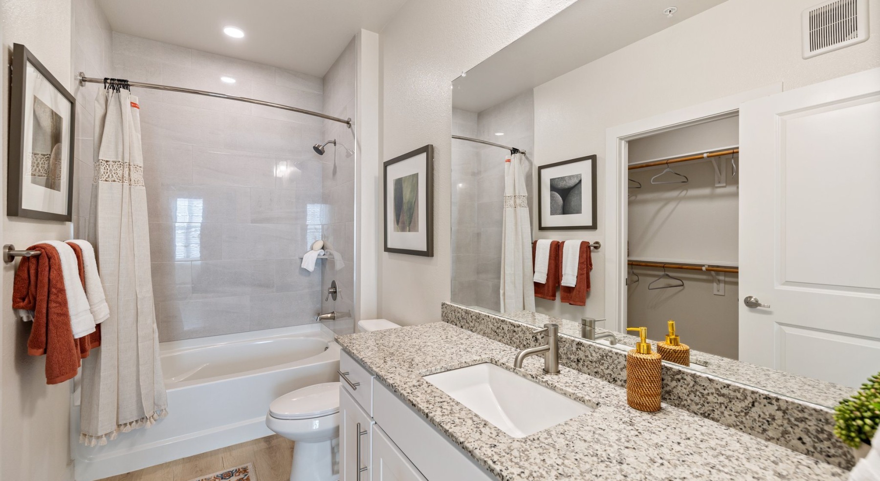 a spacious bathroom with a large mirror and ample light