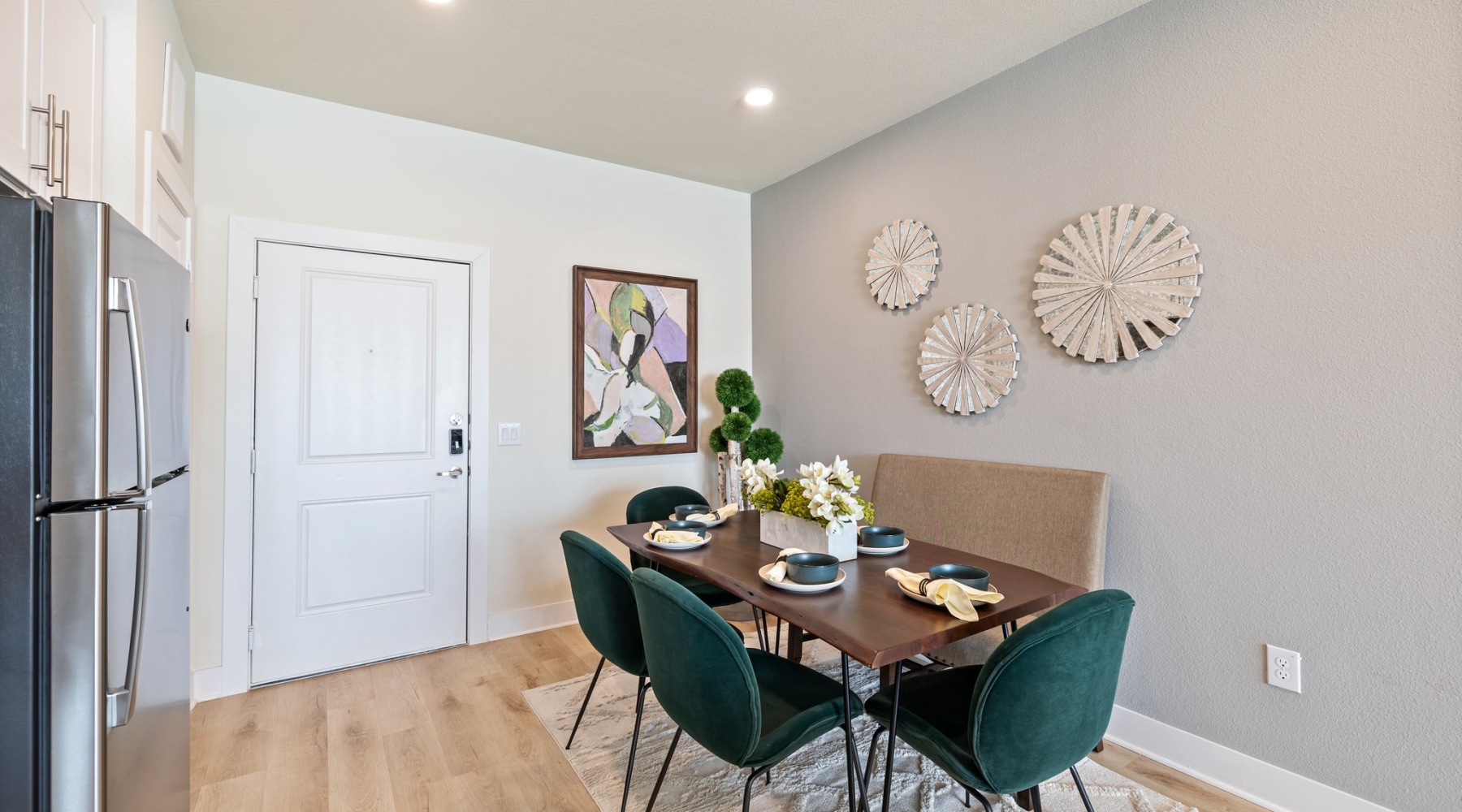 a spacious dining room with green chairs
