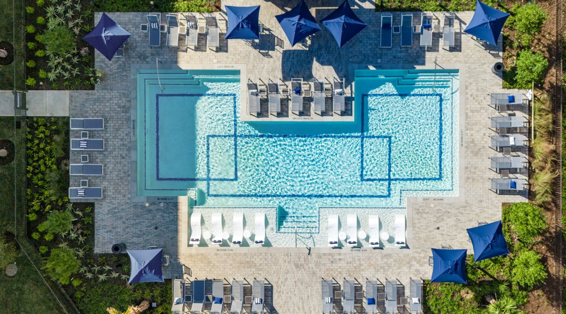 Resort-style swimming pool with lounge seating
