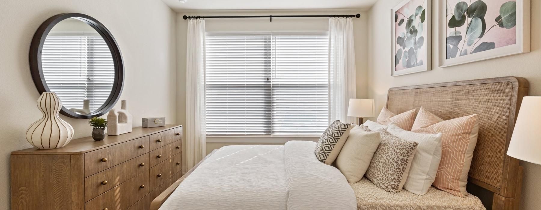 a bedroom with a bed and a mirror